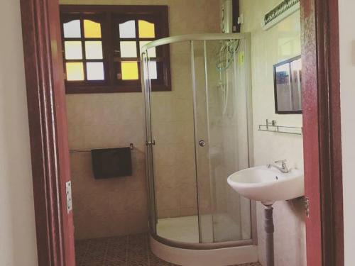 a bathroom with a shower and a sink at MILLBROOK HOUSE TERENGGANU in Kampong Pasir Puteh