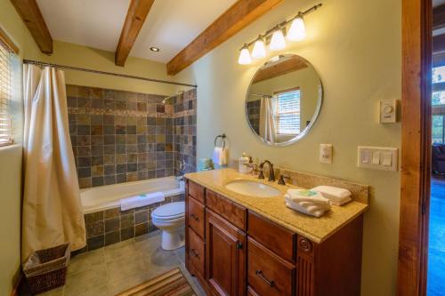 a bathroom with a sink and a toilet and a mirror at Strawberry Fields in Duck Creek Village