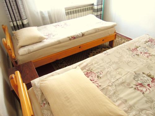 two twin beds in a room with at Arthouse in Karakol