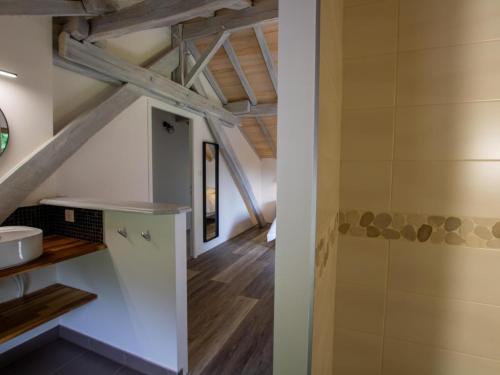 an attic kitchen with white cabinets and wooden ceilings at Maison Authentique avec Piscine, Étang Privatif et Confort Moderne en Dordogne - FR-1-616-332 in Agonac