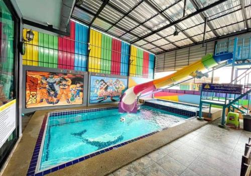 a indoor swimming pool with a water slide in a room at บ้านพักชะอำ Dream​ ​& Dear​ Fantasy​ Pool​ Villa​ Cha-am in Ban Sa