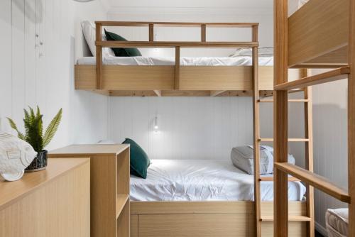 a small room with bunk beds and a desk at Ingenia Holidays Merry Beach in Kioloa