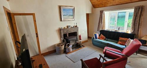 a living room with a couch and a fireplace at The Old Ferryhouse in Port Appin