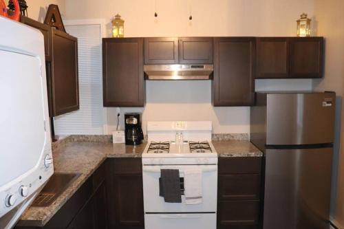 a kitchen with a white stove and a refrigerator at The Geneva Getaway in Geneva
