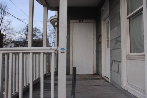 a white door on a house with a porch at The Geneva Getaway in Geneva
