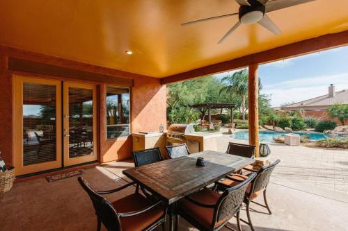 a dining room with a table and chairs on a patio at Sprawling Arizona Oasis w/ Dream Backyard in Anthem