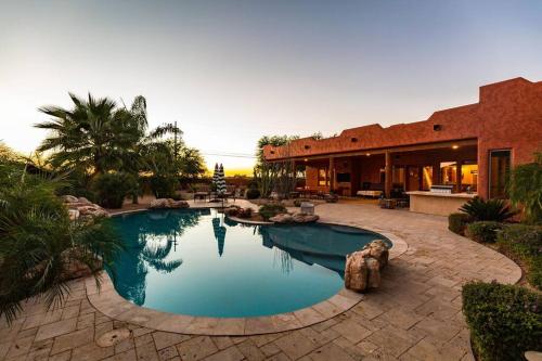 a swimming pool in front of a house at Sprawling Arizona Oasis w/ Dream Backyard in Anthem