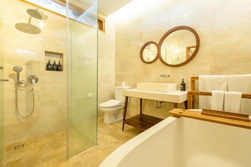 a bathroom with a shower and a sink and a toilet at Bhuwana Ubud Hotel and Farming in Ubud