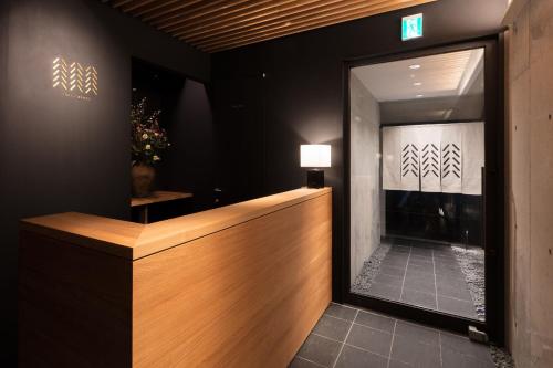 a hotel lobby with a reception desk and a mirror at 藤華/京都 in Kyoto