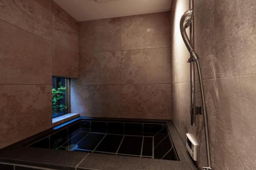 a bathroom with a shower with a glass floor at hotori in Kyoto