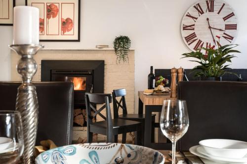 a dining room with a table and a fireplace at Birch House in Daylesford