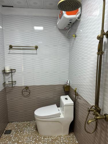 a bathroom with a white toilet and a shower at Ultra View Homestay in Sapa