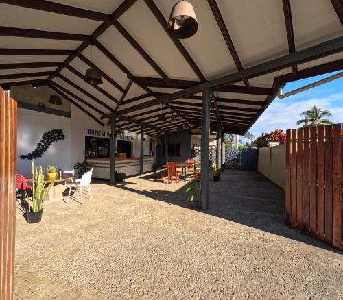 an outdoor patio with awning and a table and chairs at Tropical Plaza Apt in Nadi