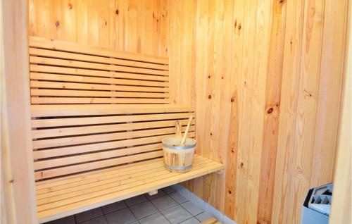 a sauna with a drink on a wooden wall at Holiday Home Limfjordsvangen Snedsted X in Skyum