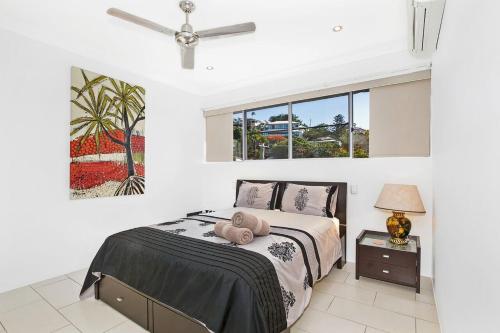 a bedroom with a bed with a teddy bear on it at EXECUTIVE PROPERTIES IN NORTH WARD TOWNSVILLE and ON MAGNETIC ISLAND in Townsville