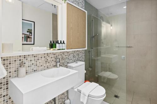 a bathroom with a sink and a toilet and a shower at Escape To Melbourne - Stylish 1 Bedroom-Gym - Aircon -Balcony in Melbourne