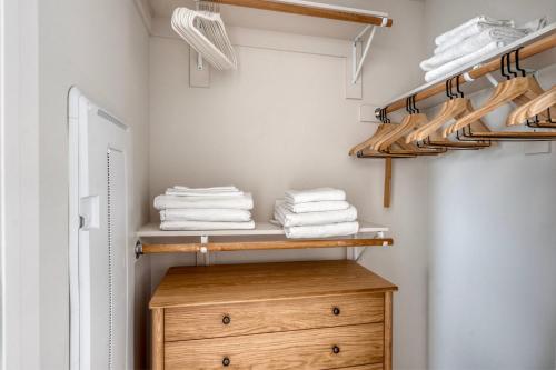 a closet with a wooden dresser and towels at SoMa 1br w bike storage parking nr Bart SFO-1424 in San Francisco