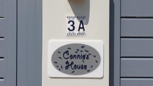 a door tag with a sign that reads games revise at Connie's Beach House in Kos