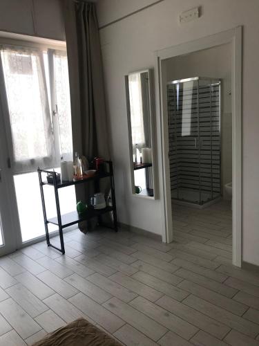 a living room with a mirror and a tiled floor at fronteMare faleria1 in Porto SantʼElpidio
