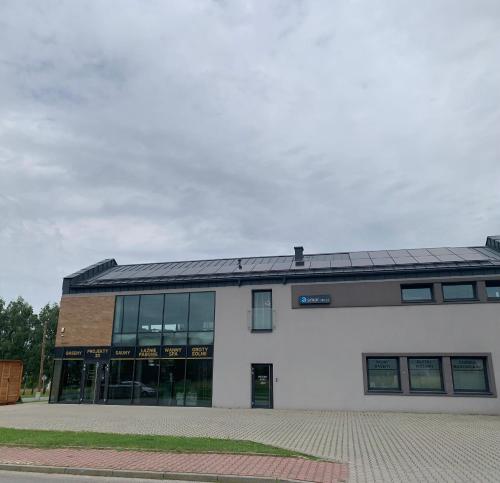 a building with a solar roof on top of it at Apartament 106 in Andrychów