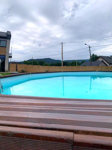a large blue swimming pool in a building at Apartament 106 in Andrychów