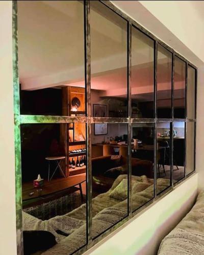 a reflection of a room in a glass wall at Appart hyper centre Font Romeu in Font Romeu Odeillo Via