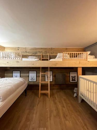 a bedroom with two bunk beds and pictures on the wall at Appart hyper centre Font Romeu in Font-Romeu-Odeillo-Via