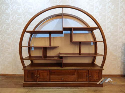 a wooden display cabinet with a round mirror at Mciti Suites by Evernent in Miri