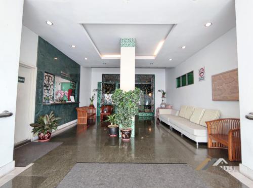 a living room with a couch and a table at Mciti Suites by Evernent in Miri