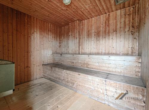 a wooden sauna with a bench in a room at Mciti Suites by Evernent in Miri