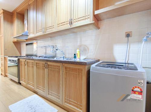 a kitchen with a sink and a dishwasher at Mciti Suites by Evernent in Miri
