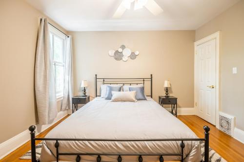 a bedroom with a bed and two night stands at Cozy 5 Bedroom House in Downtown Toronto by GLOBALSTAY in Toronto