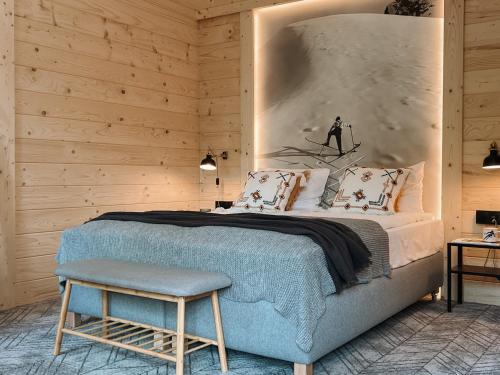 a bedroom with a bed and a wall with a picture of a skier at Dom Górski 878 mnpm in Zakopane