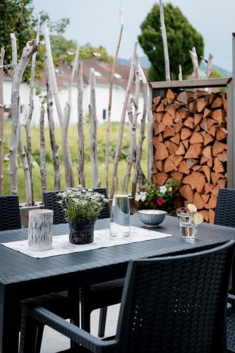 a black table with glasses and plants on it at Ländleapartments in Höchst