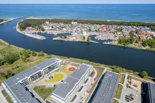 an aerial view of a marina and a city at Wellness Resort & SPA Dziwnów Apartments with Parking by Noclegi Renters in Dziwnów