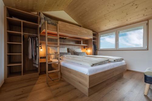 a bedroom with two bunk beds and a window at Ländleapartments in Höchst