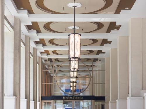 a chandelier hanging from the ceiling of a building at JR Kyushu Hotel Blossom Fukuoka in Fukuoka