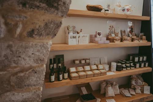 a shelf filled with lots of bottles and boxes at Antica Dimora Del Gruccione, Albergo diffuso in Santu Lussurgiu