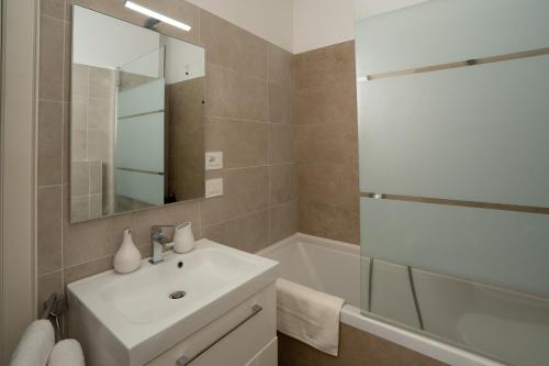 a bathroom with a sink and a tub and a mirror at Ancient Rome in Rome