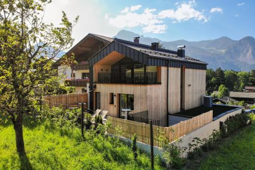 a house on a hill with mountains in the background at Haus Sonnblick Chalet in Reith im Alpbachtal