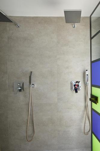 a shower in a bathroom with a glass door at Thadeos Villa with private jetted Pool in Fira