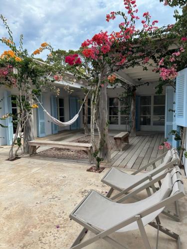 a deck with a chair and flowers on it at CASA MAGALI in Sant Francesc Xavier