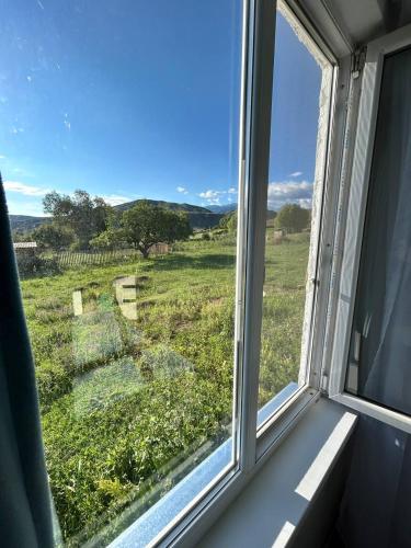 a window with a view of a field at Гостевой дом KOLSAY ROOM in Saty
