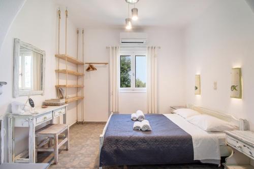 a bedroom with a bed with two teddy bears on it at Green Retreats 3 Paros in Isterni