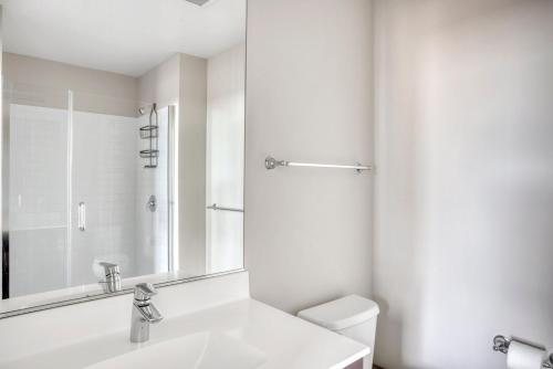 a white bathroom with a sink and a mirror at ChinatownTheater District 2br w gym wd nr T BOS-224A in Boston