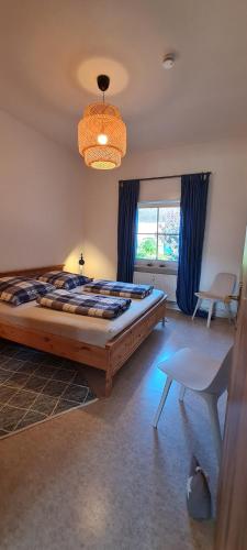 a bedroom with a large bed and a chandelier at Zum Kranich in Luckau