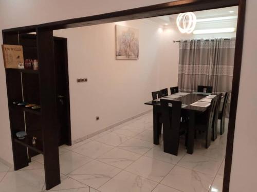 a dining room with a black table and chairs at Sweet home 