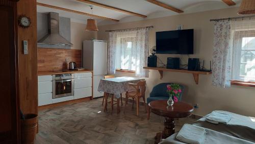 a kitchen with a table and a dining room at Kasita 