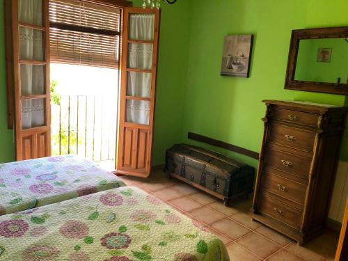 a bedroom with a bed and a dresser and a window at CASA JUANITO PEÑA in Parauta