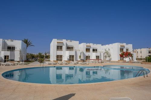a large swimming pool in front of some buildings at Olives at Santa Monica in Marsa Matruh